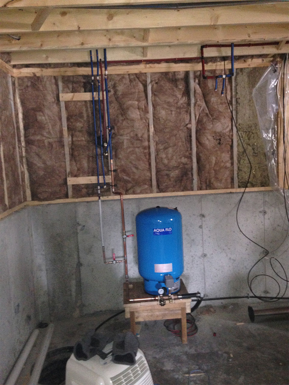 newly installed plumbing with water pressure tank