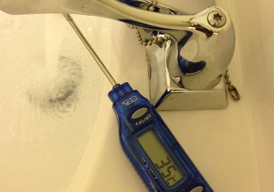 measuring water temperature on a newly installed sink