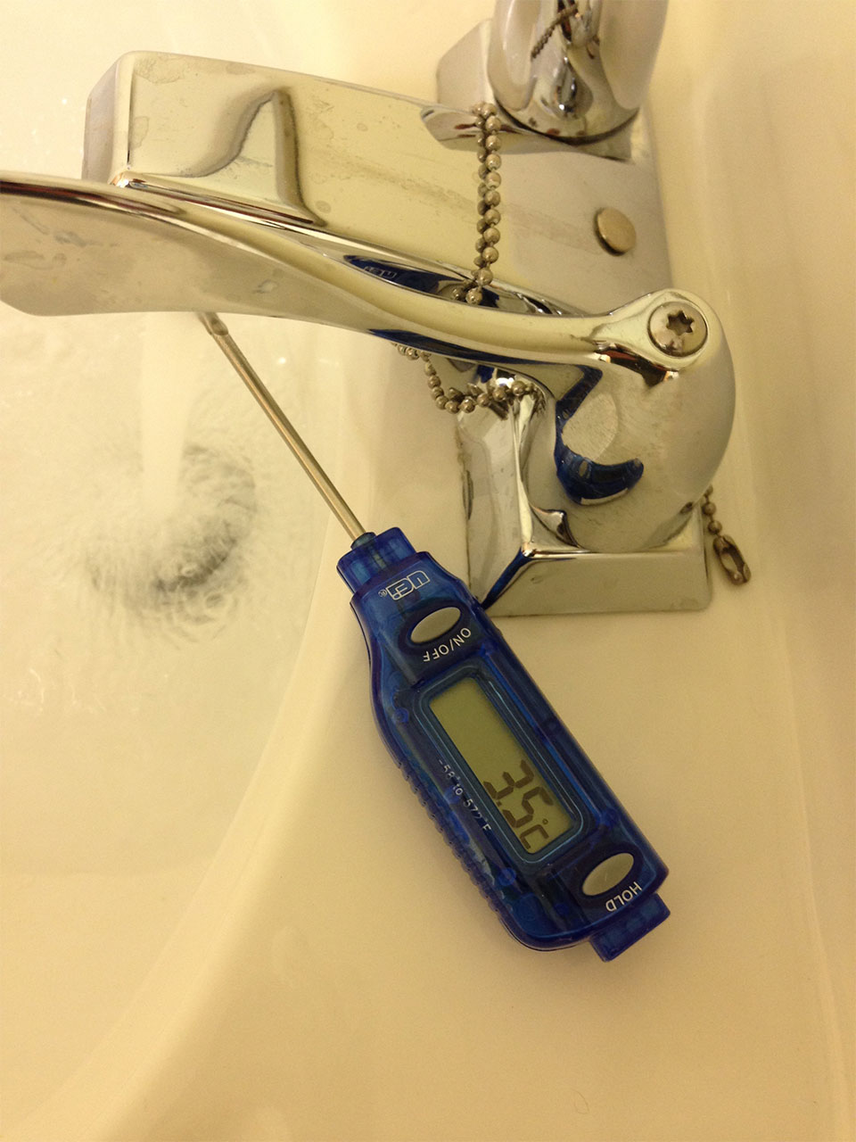 measuring water temperature on a newly installed sink