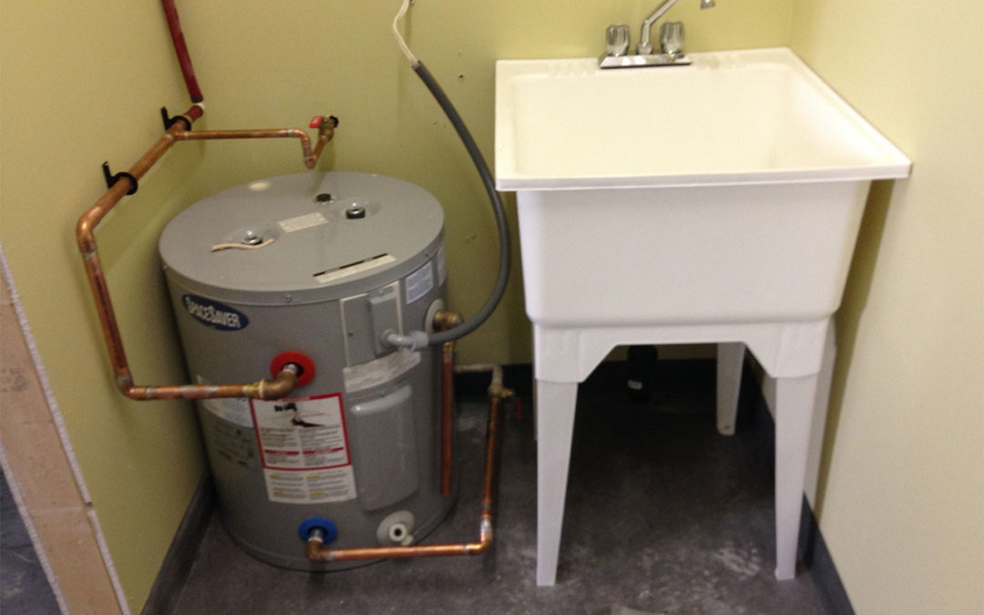 newly installed hot water tank and laundry sink