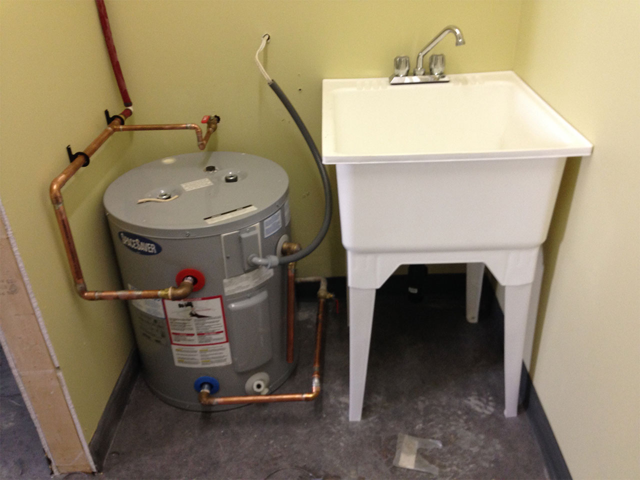 newly installed hot water tank and laundry sink